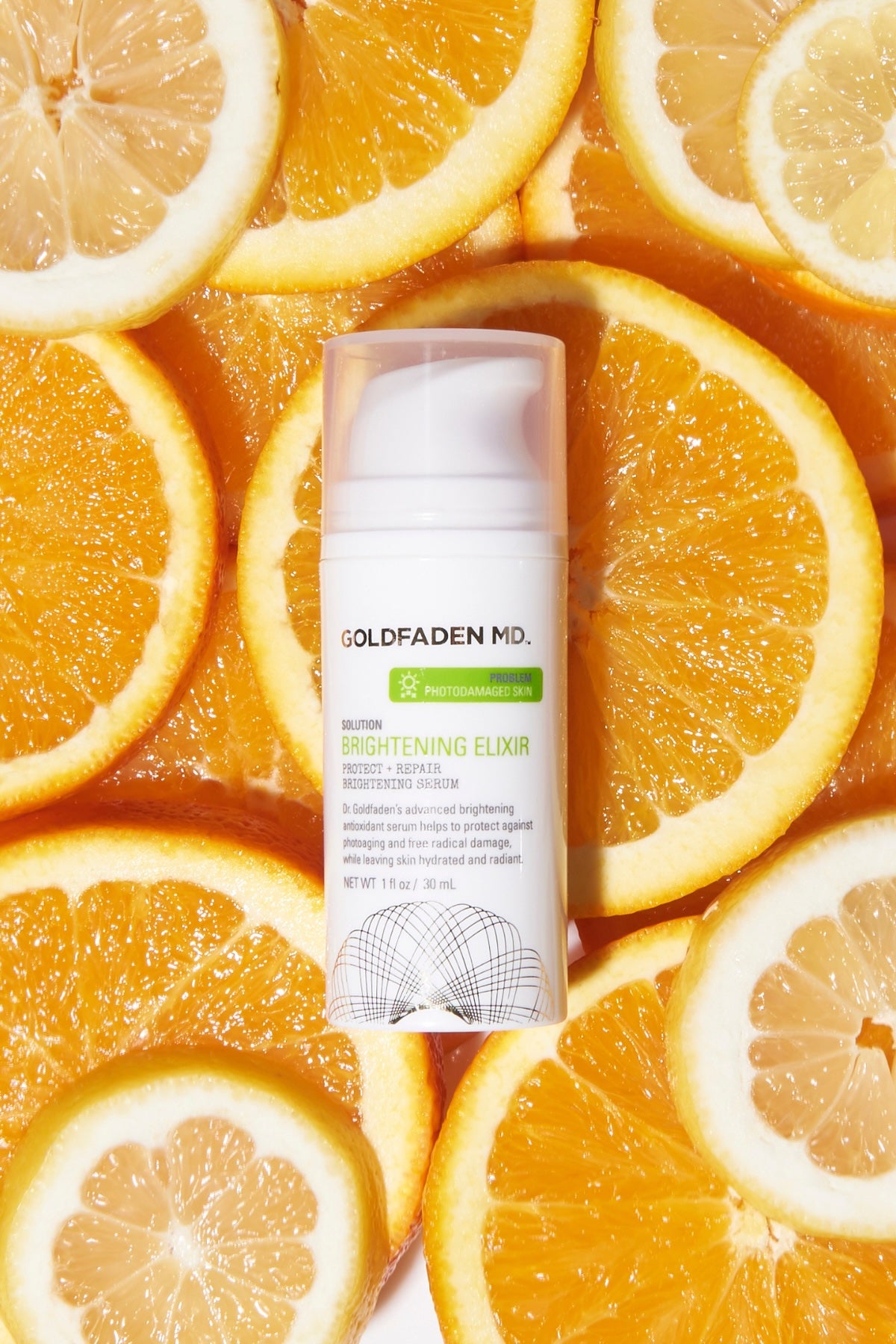 Goldfaden MD Brightening Elixir serum surrounded by citrus slices